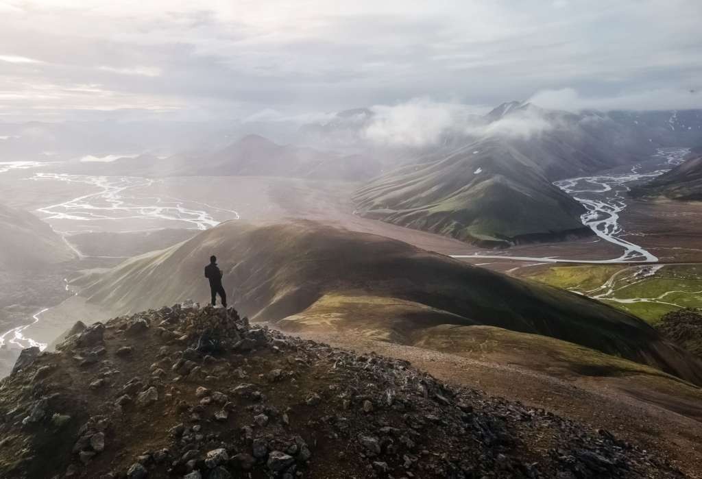 Hiker in Iceland watching the landscape from the top of a mountain.. Some of the best hiking and photography locations in Iceland