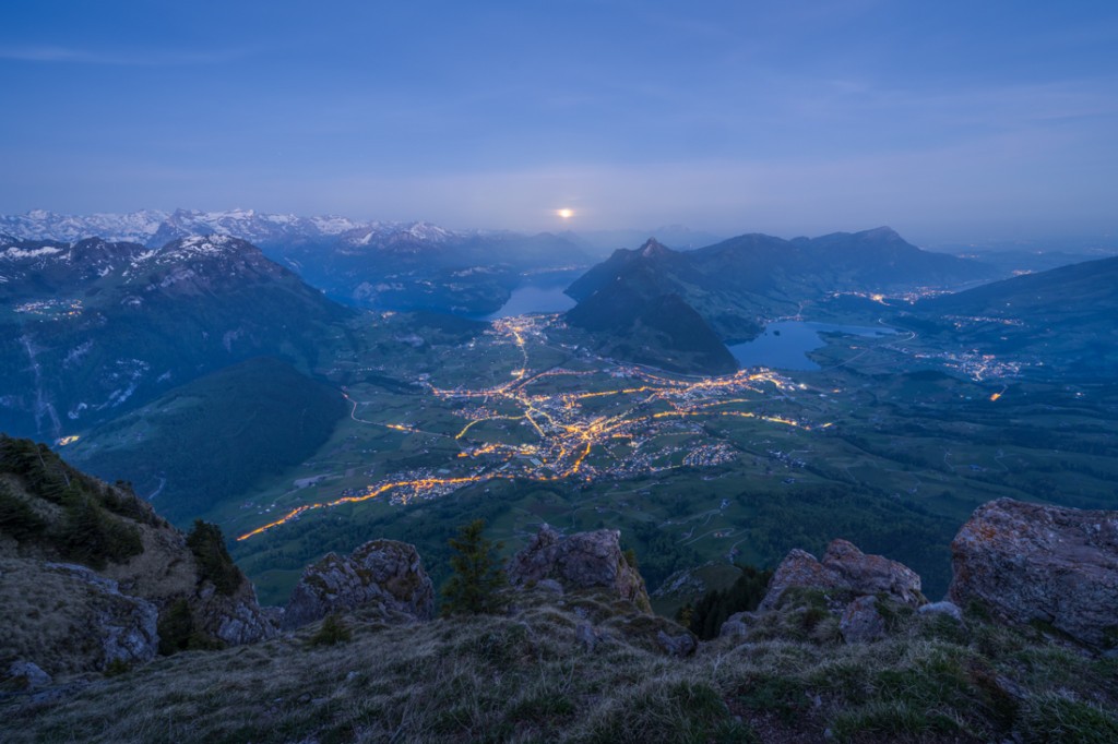 Blue hour on top of the Grosser Mythen toward Schwyz and Lake Lucerne, with the mon setting in the background