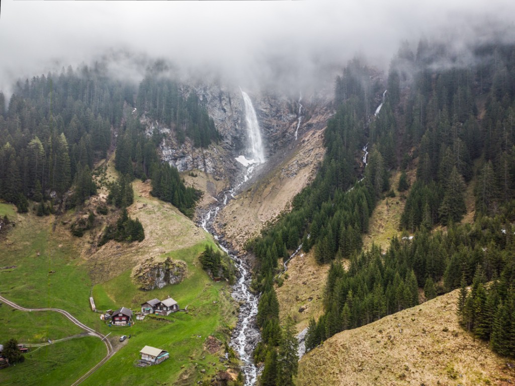 Drone shot waterfall in the mountain with fog