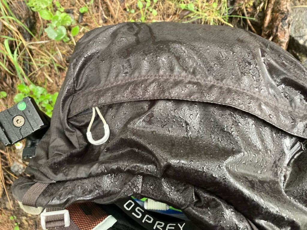 Hiking backpacks for photographers and top lid drenched in water
