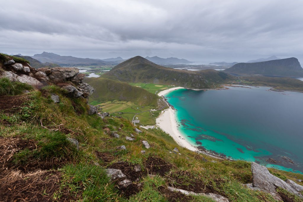 Hike to Mannen, view from the top of a Norwegian mountain over the white sand beach and the sea