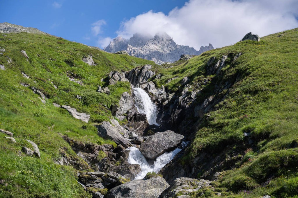 The Sidelengletscher and Alber Heim Hütte Hike, a waterfall on the trail