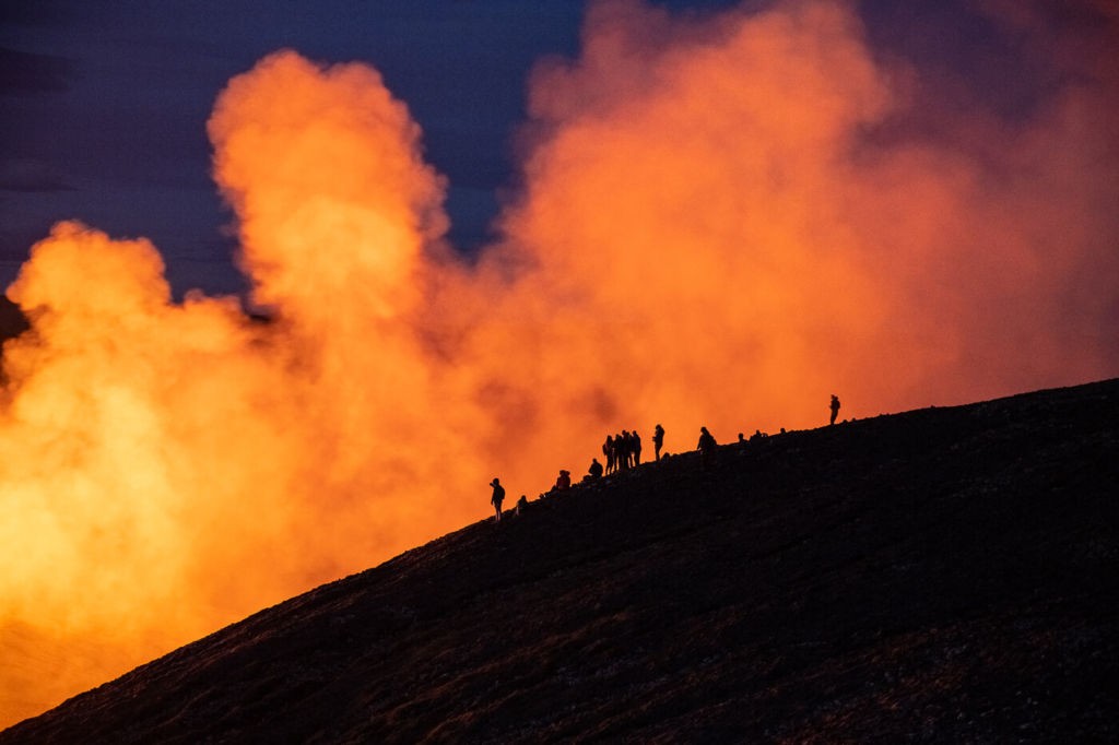 Group of people looking at the Fagradalsfjall eruption from a hill