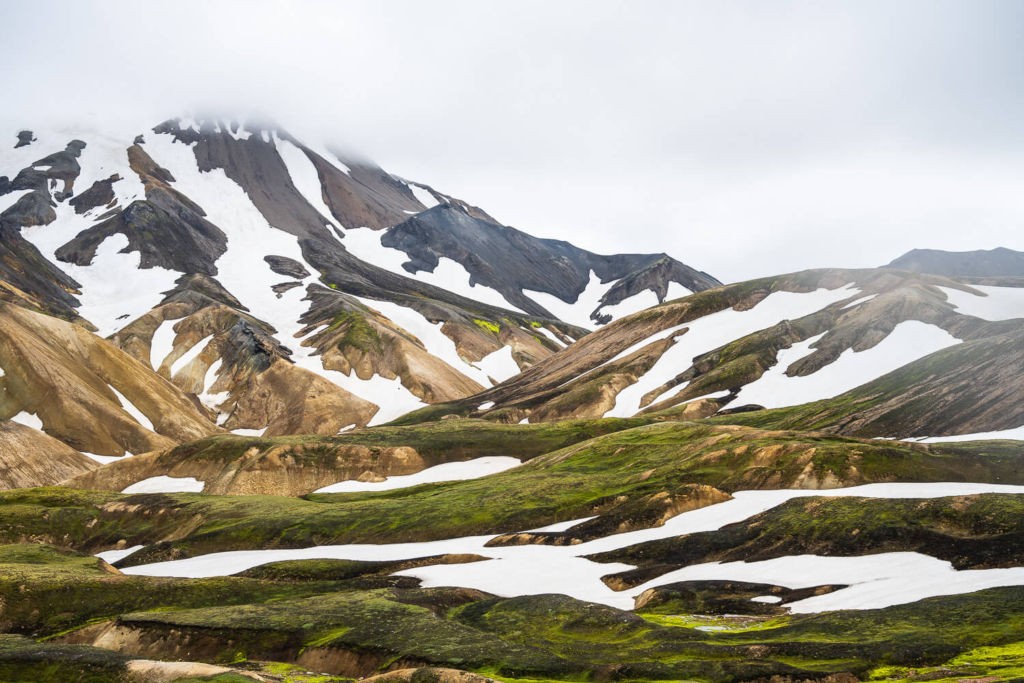 Hills partially covered in snow in landmannalaugar