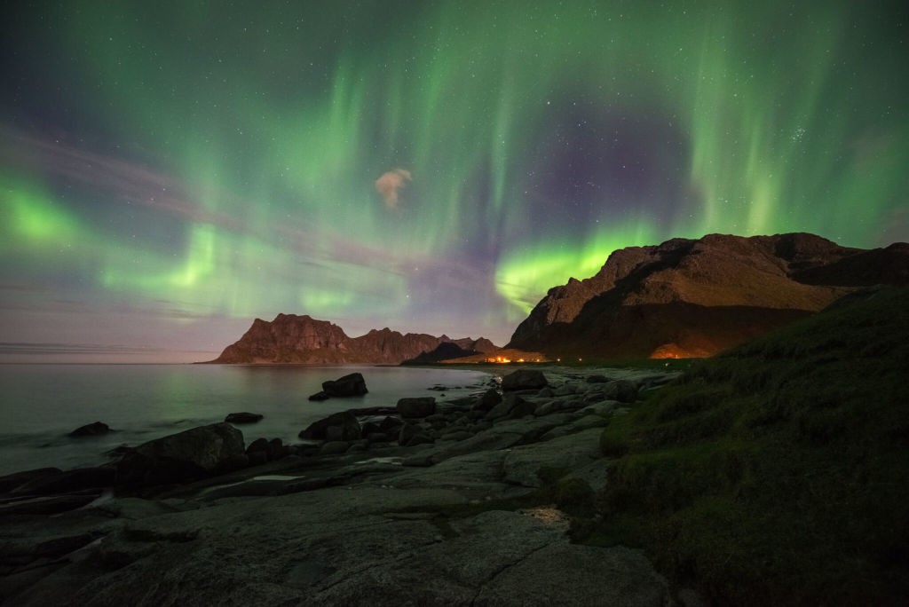Aurora Borealis filling the sky over a beach in Norway