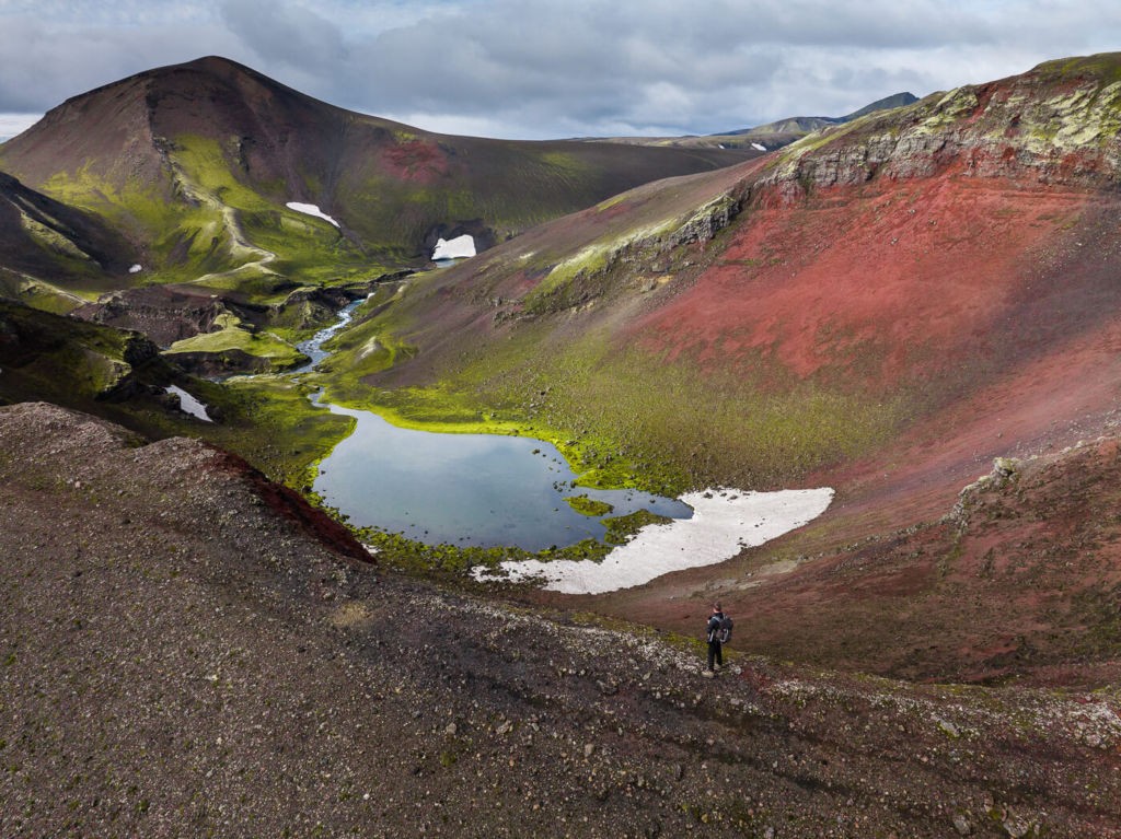 Raudibont, a gem in the Highlands and hiker watching the landscape from the rim of the crater