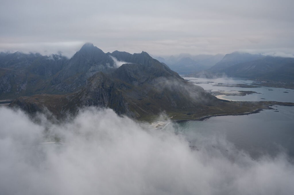 Mountain in a Norwegian fjord engulfed in clouds