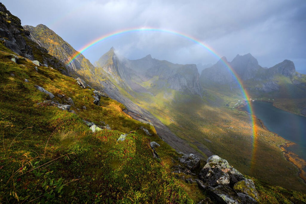 A rainbow on the mountains in the norwegian fjord of Kjerkfjorden