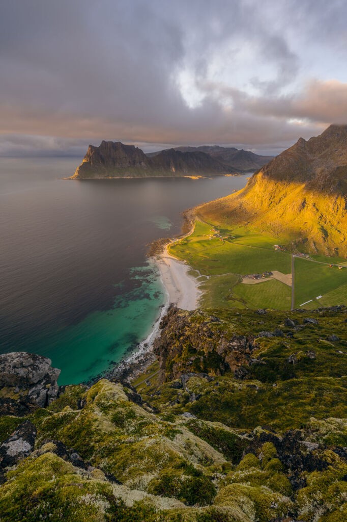 View from the top of Veggen toward Uttakleivveien beach at sunset. The light lies the mountain and the Norwegian see