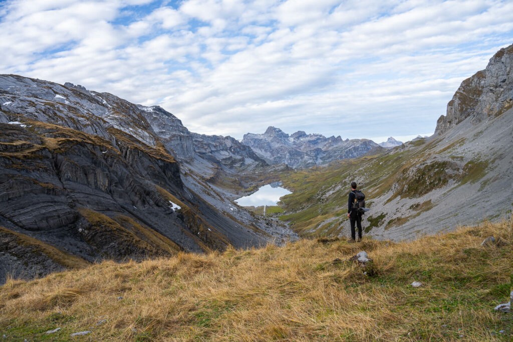 Hiker watching an alpine panorama and alpine lake