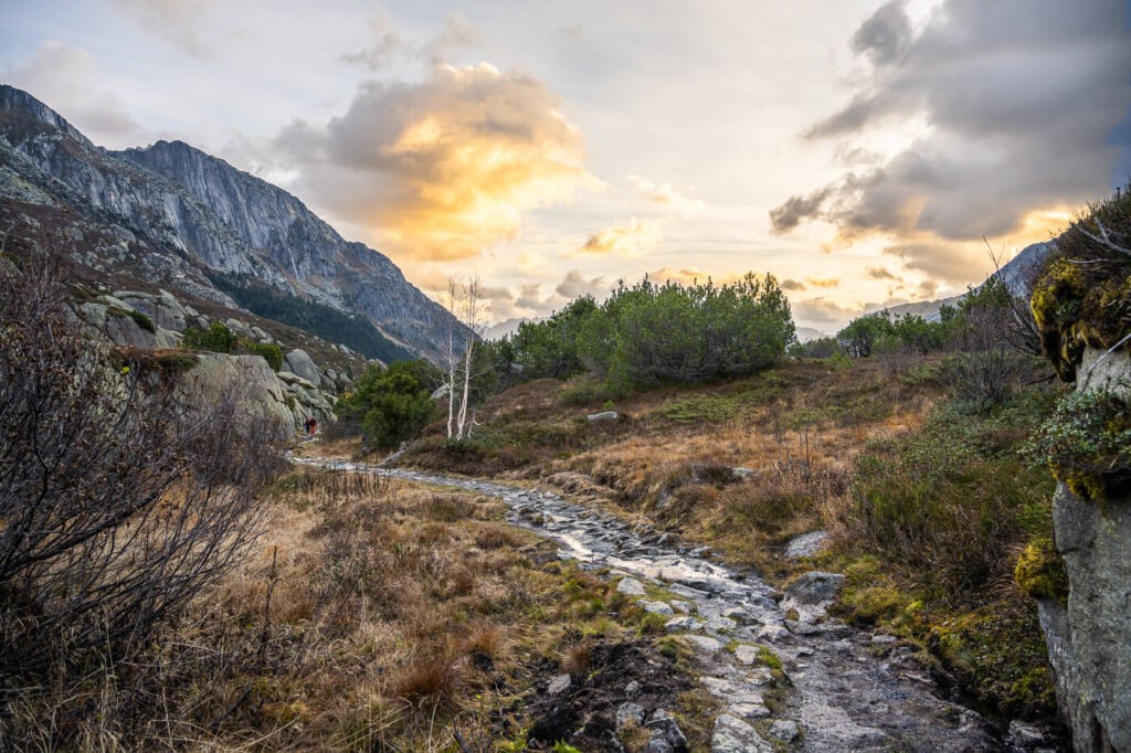 A stone-paved trail on the Göscheneralpsee- hike, with sunrise in the background