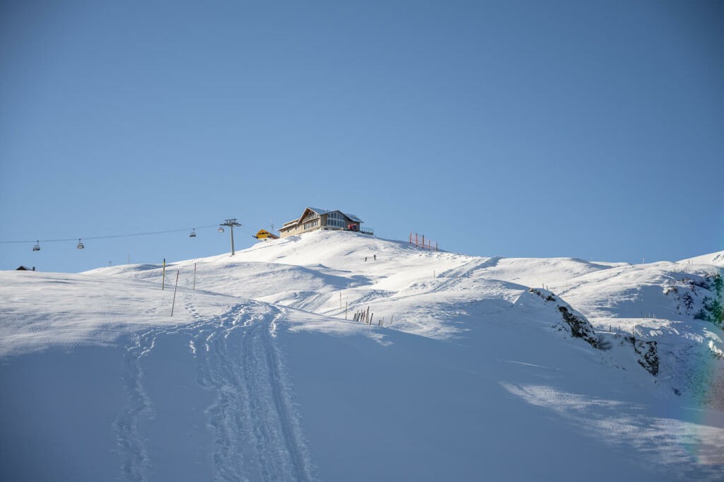 A hut on top of a mountain in winter