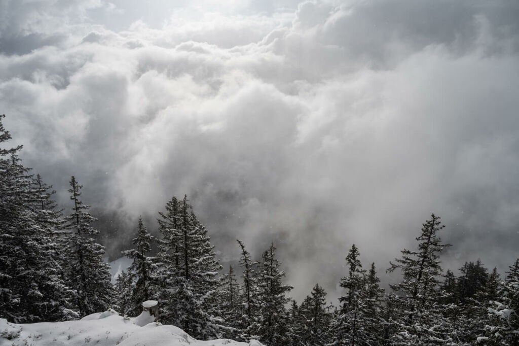 Clouds surrounding a snowy landscape