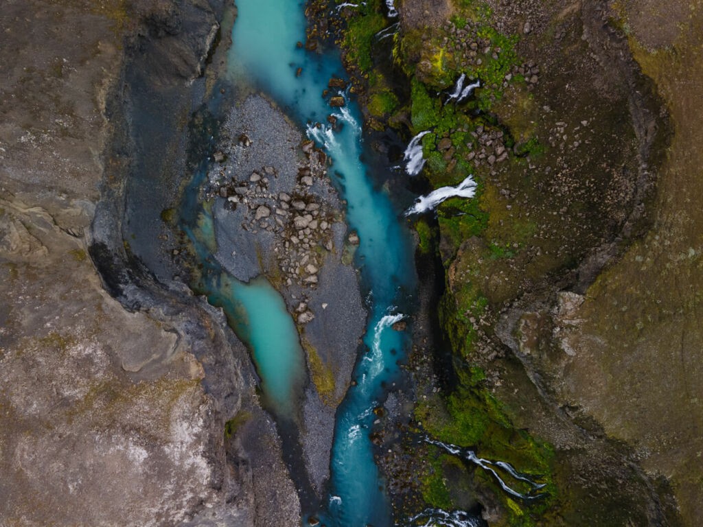Photo of a canyon in Iceland with blue water taken while flying a drone