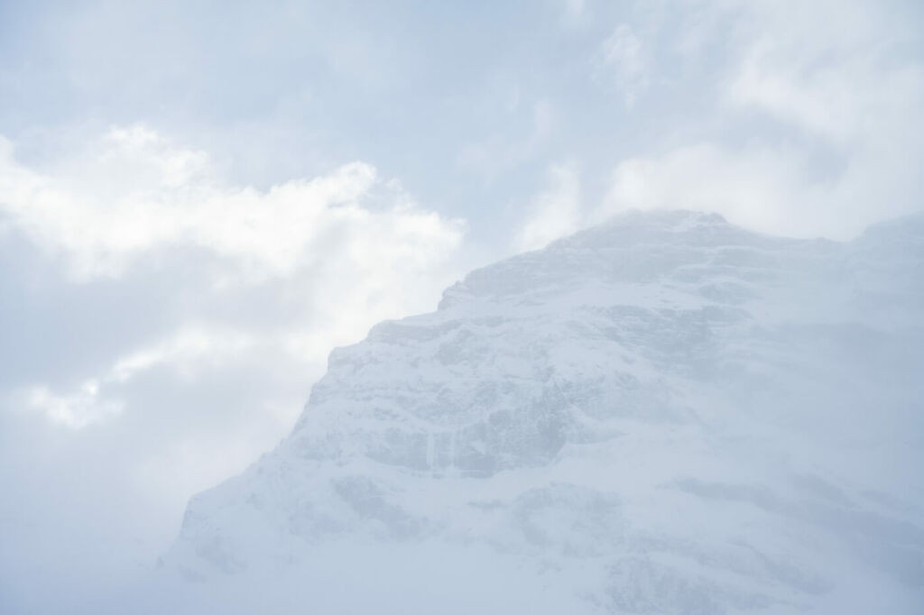 Detail of a mountain peak on a cloudy and snowy day
