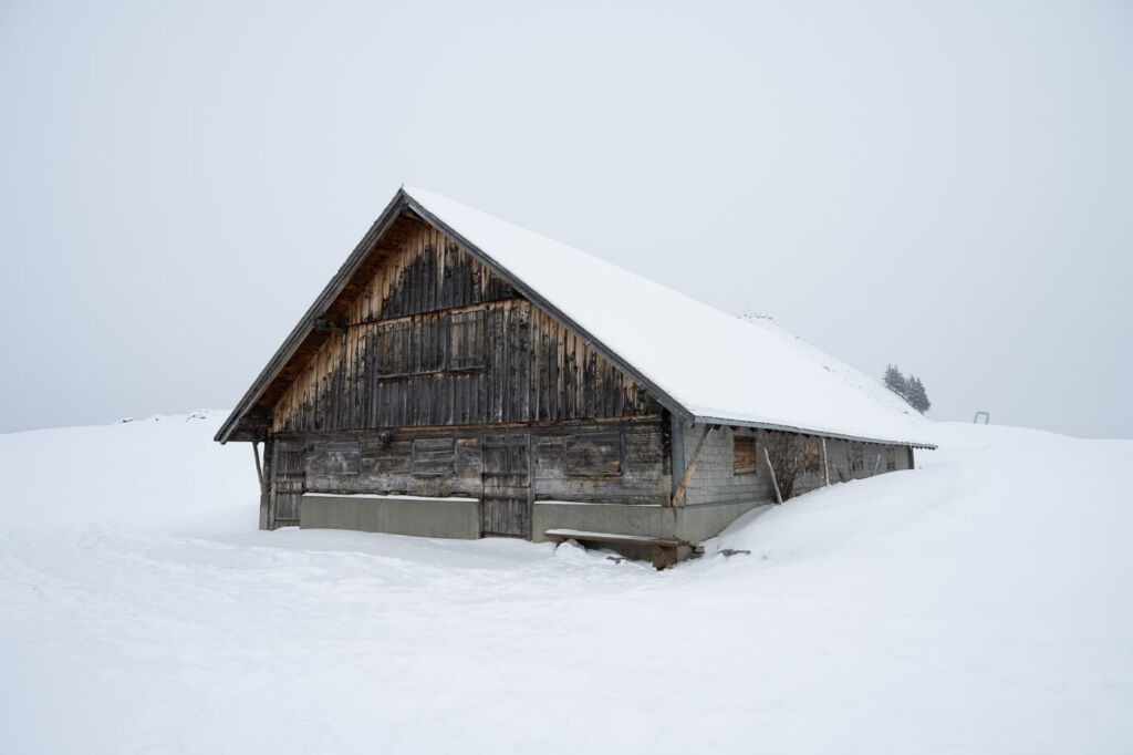 mountain hut under the snow next to a snowshoe trail in Engelberg