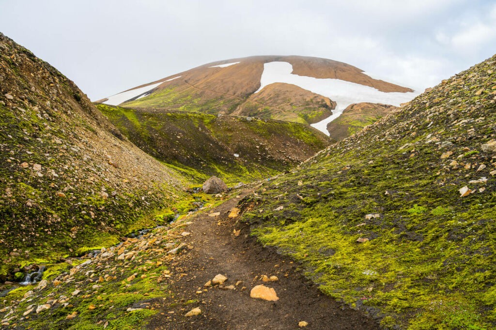 view of a trail in the highlands of Iceland with the mountain Skalli in the background