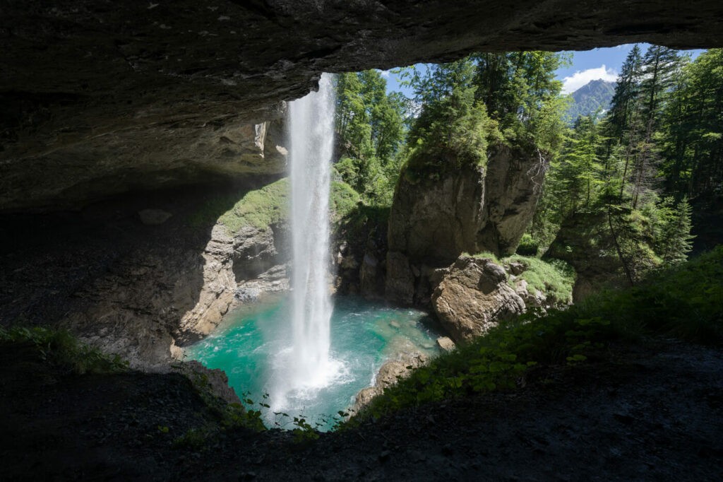 Panorama from a cave showing the Berglistüber waterfall in Switzerland