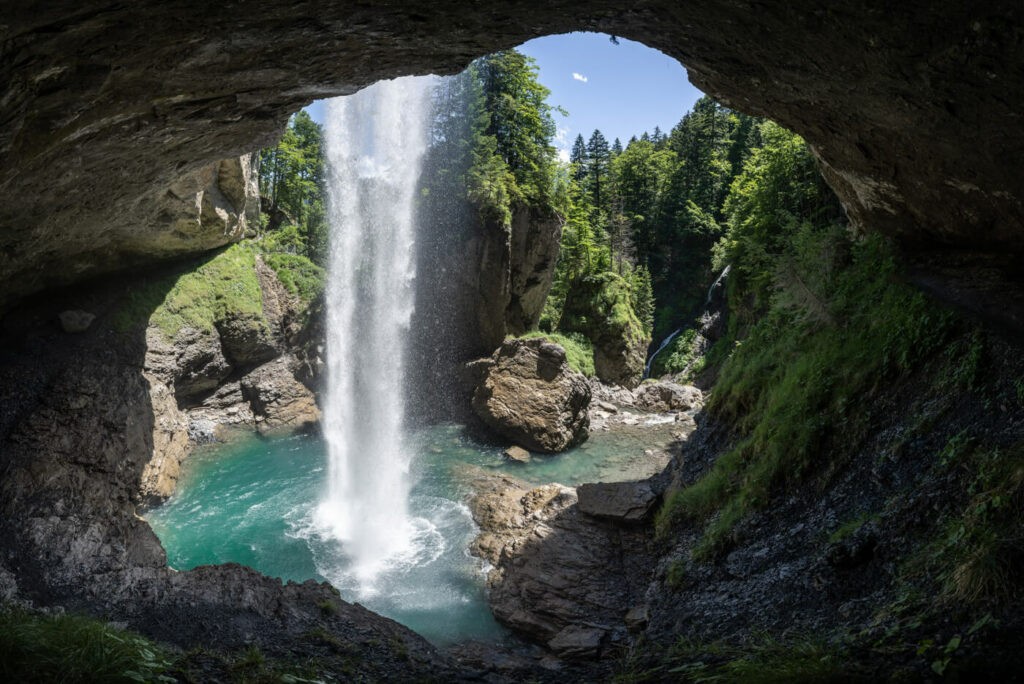 Panoramic image of a cave with a waterfall