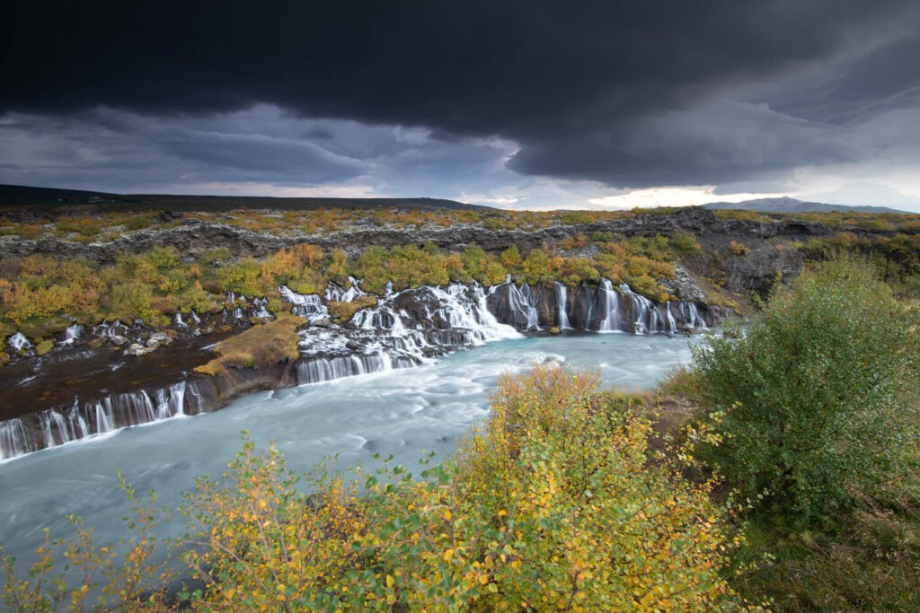 Hraunfossar waterfalls downstream of the Barnarfoss waterfall on an Autumn day