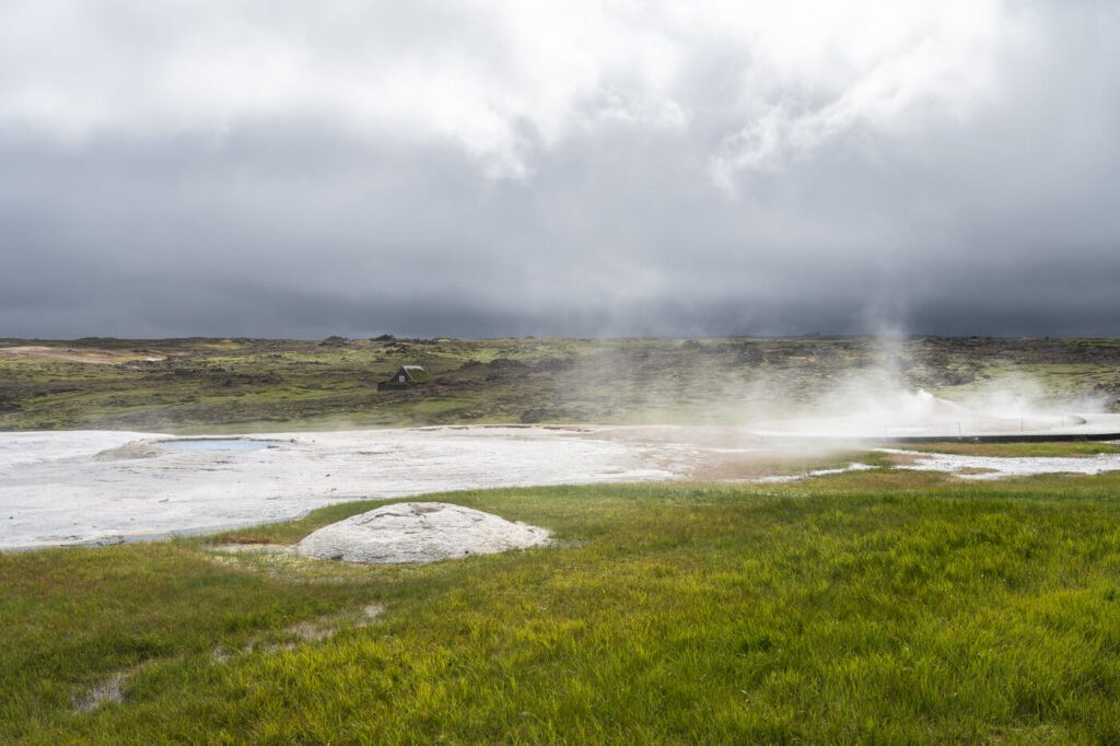 Green meadow around a geothermal area in Iceland
