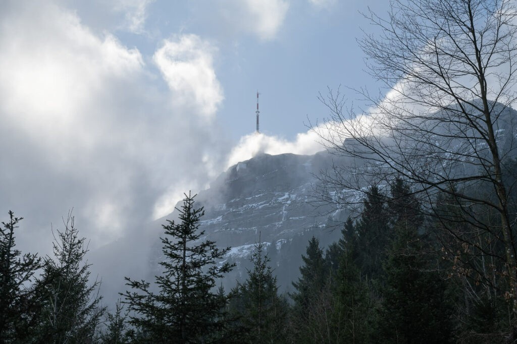Summit of a mount in switzerland with a mast on top of it