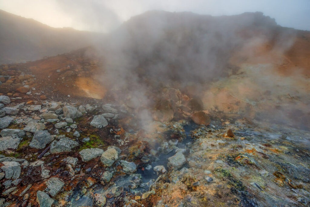 Steaming hot blue river on Seltún and Hverafjall Hike in a geothermal area near Krysuvik