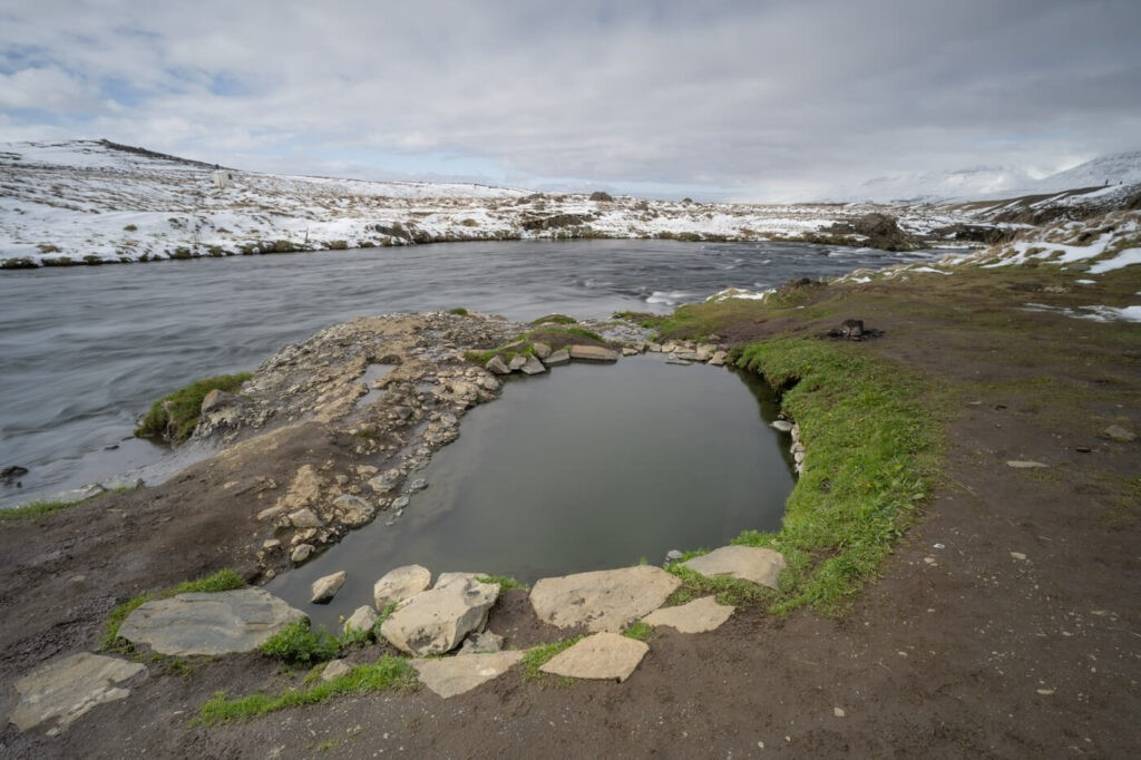 The Fosslaug hot spring upstream of the Reykjafoss Waterfall
