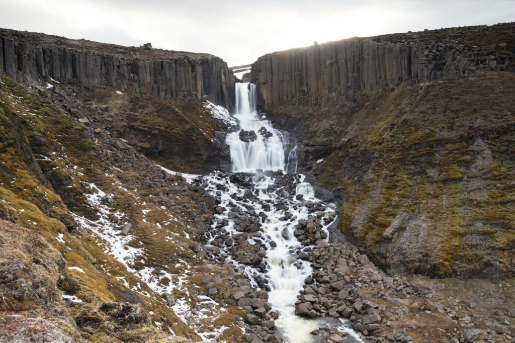 Stuðlafoss waterfall surrounded by basal columns in the Waterfall Circle hike in Laugarfell, Iceland.