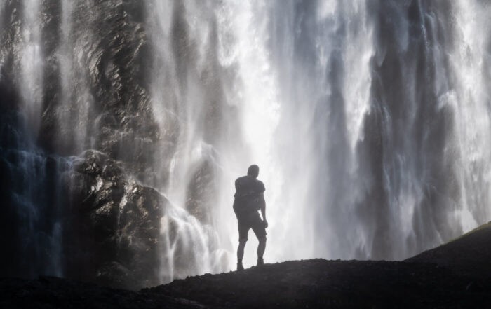 SIlohuette of an HIker watching The Engstligen Falls during a Hike