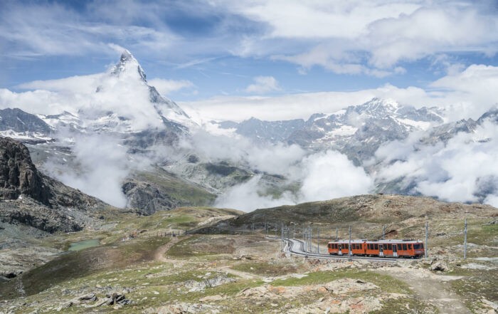 The Matterhorn and the red Matterhorn train climbing up to the Gornergrat