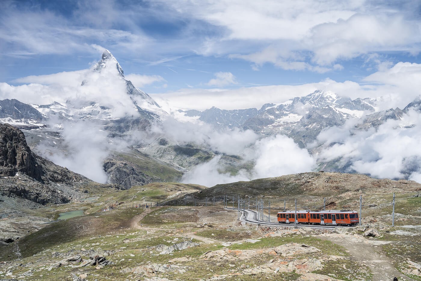 The Matterhorn and the red Matterhorn train climbing up to the Gornergrat