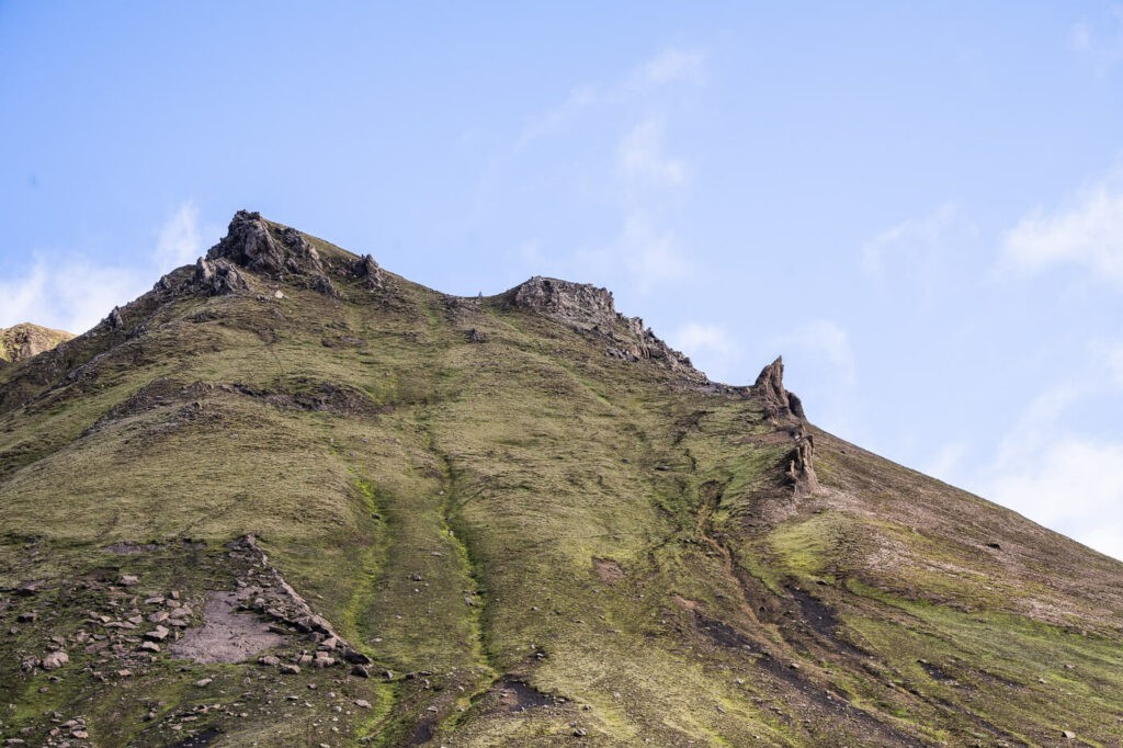 Green mountain on Iceland with a blue sky background