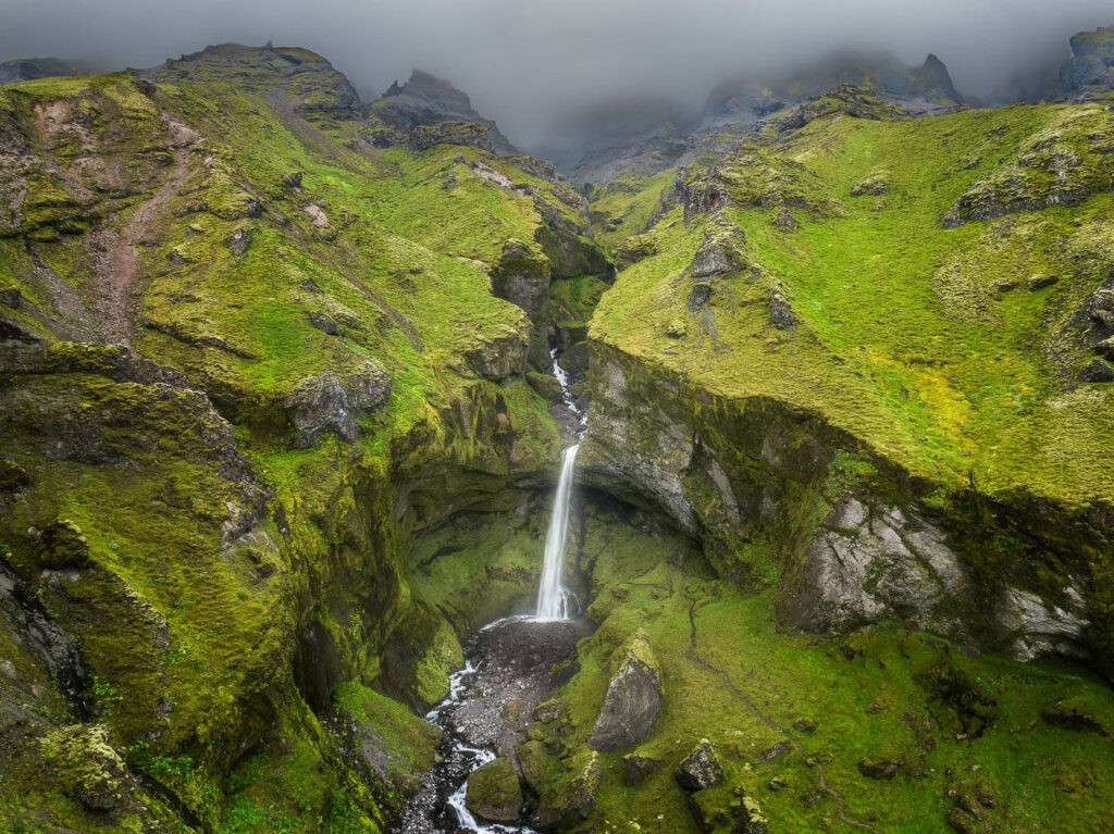 Sitgafoss Waterfall in a green lush valley