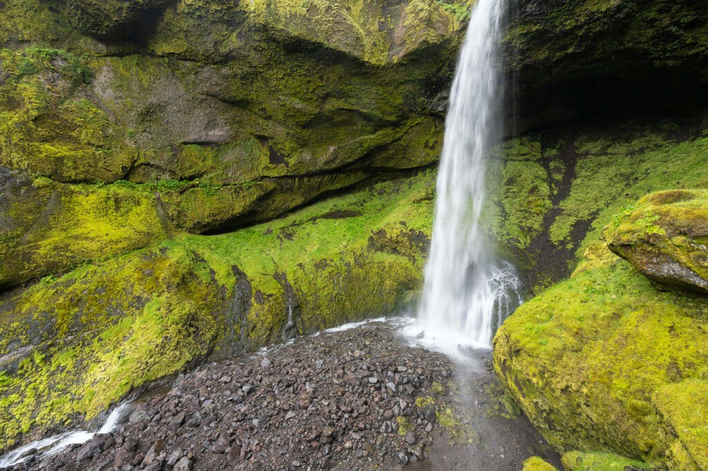 Waterfall in Iceland surrounded by green moss