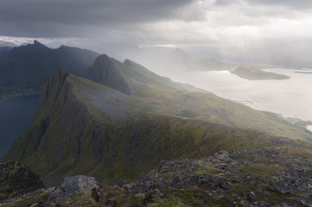 Rain and light in the distance above a ridgeline on the norwegian island of senja.