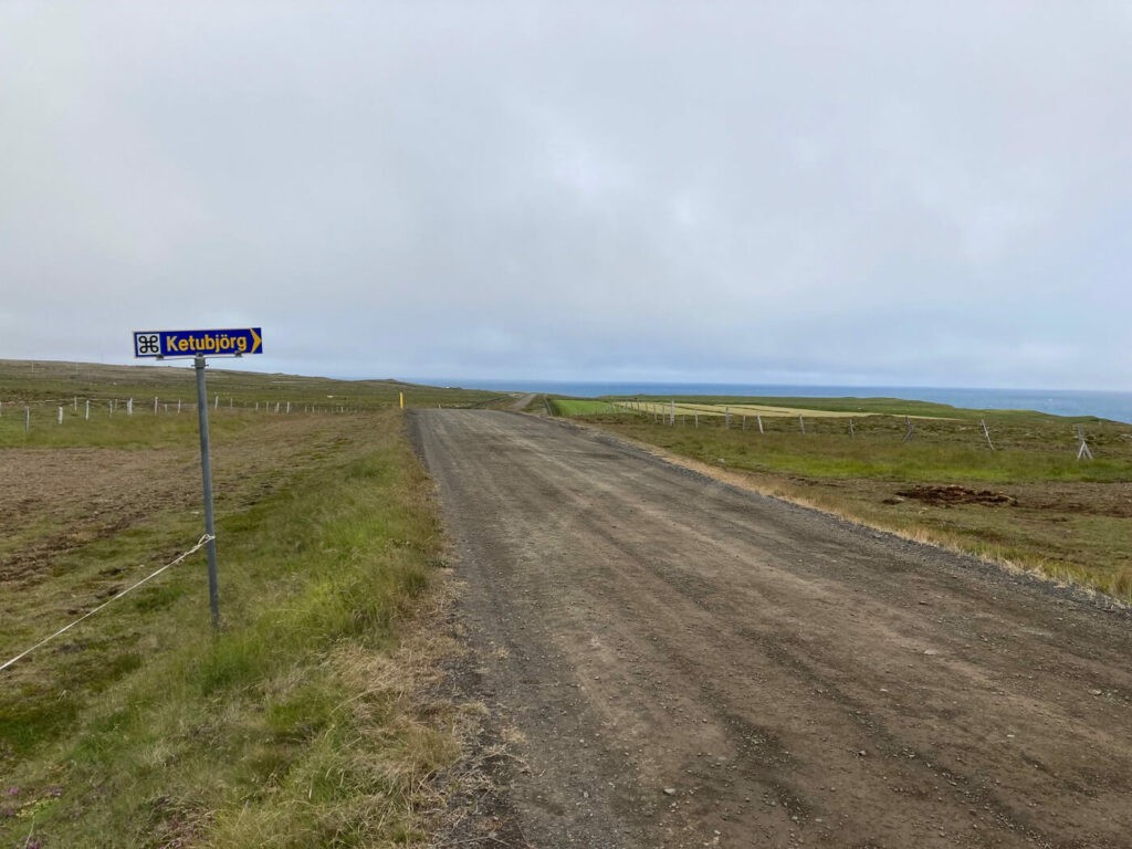 Grace road 744 in Iceland and a road sign pointing to the Ketubjörg Cliffs and Waterfalls.
