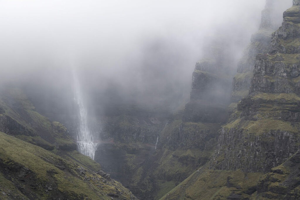 Waterfall and canyon in Iceland barely visit ble through the clouds