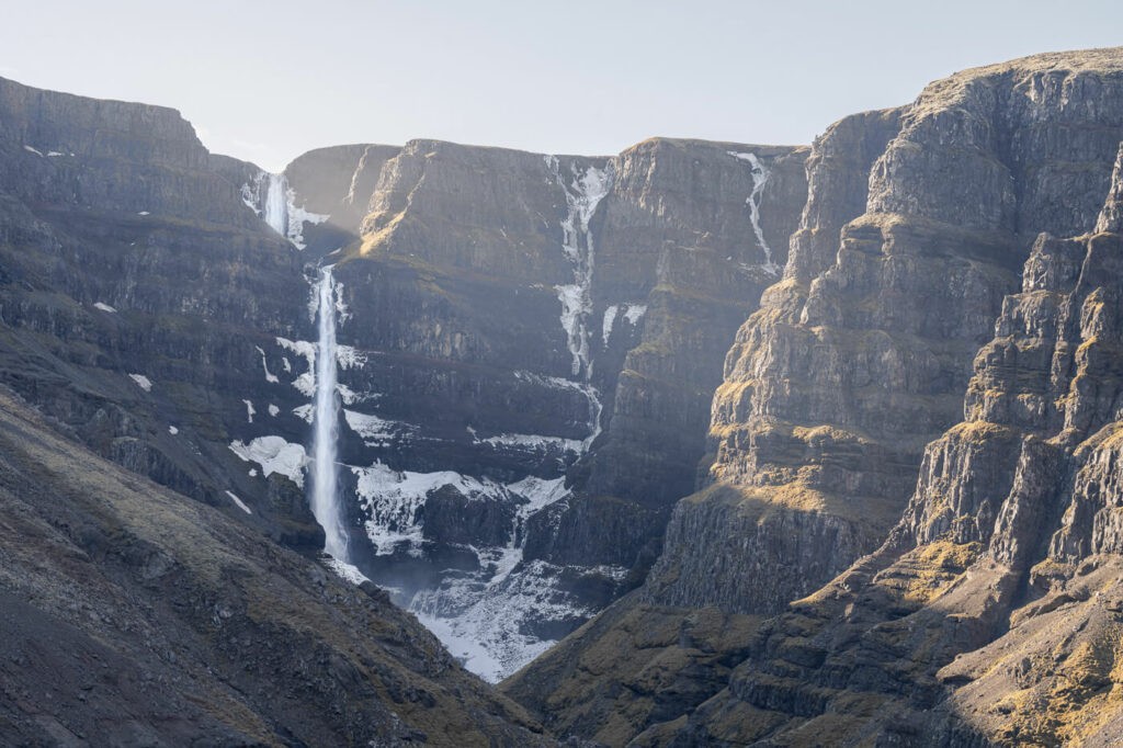Strutsfoss, a waterfall in iceland, in late spring wit still some snow and ice around it