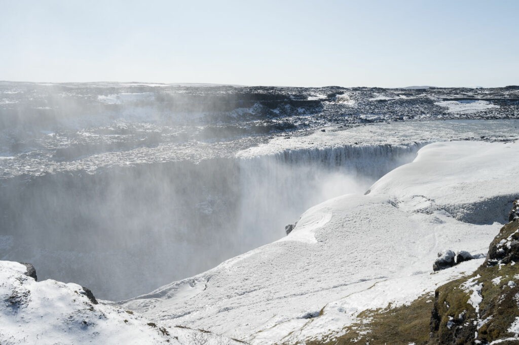 The Waterfall Dettifoss surrounded by Snow on a sunny day