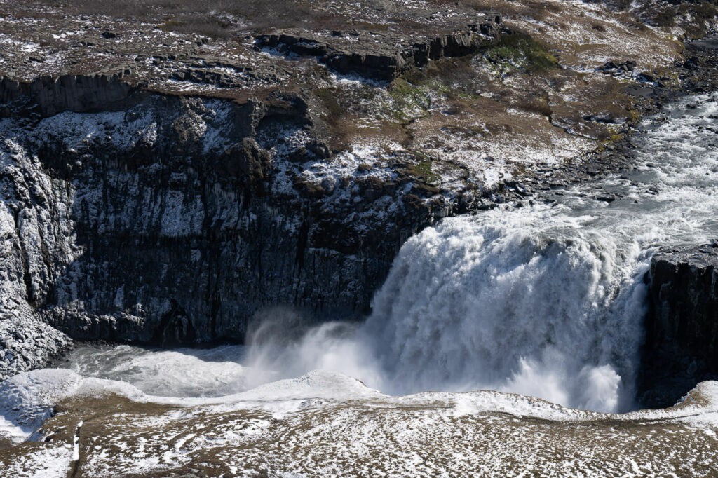 Hafragilsfoss Waterfalls falling into a canyon.