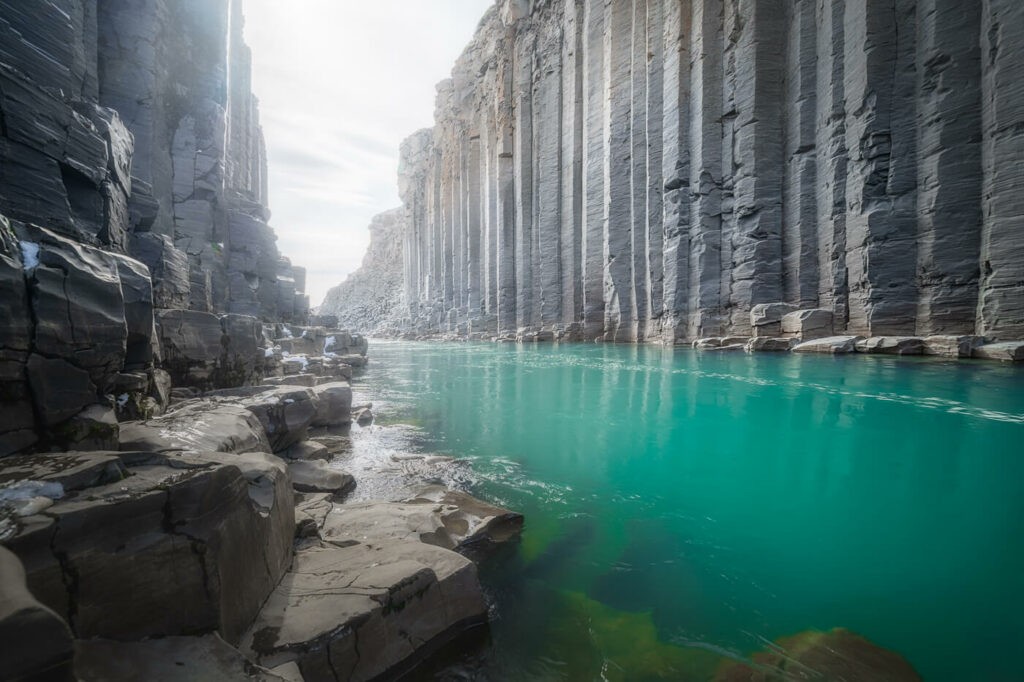 Stuðlagil canyon and its basalt columns and its emeral green waters