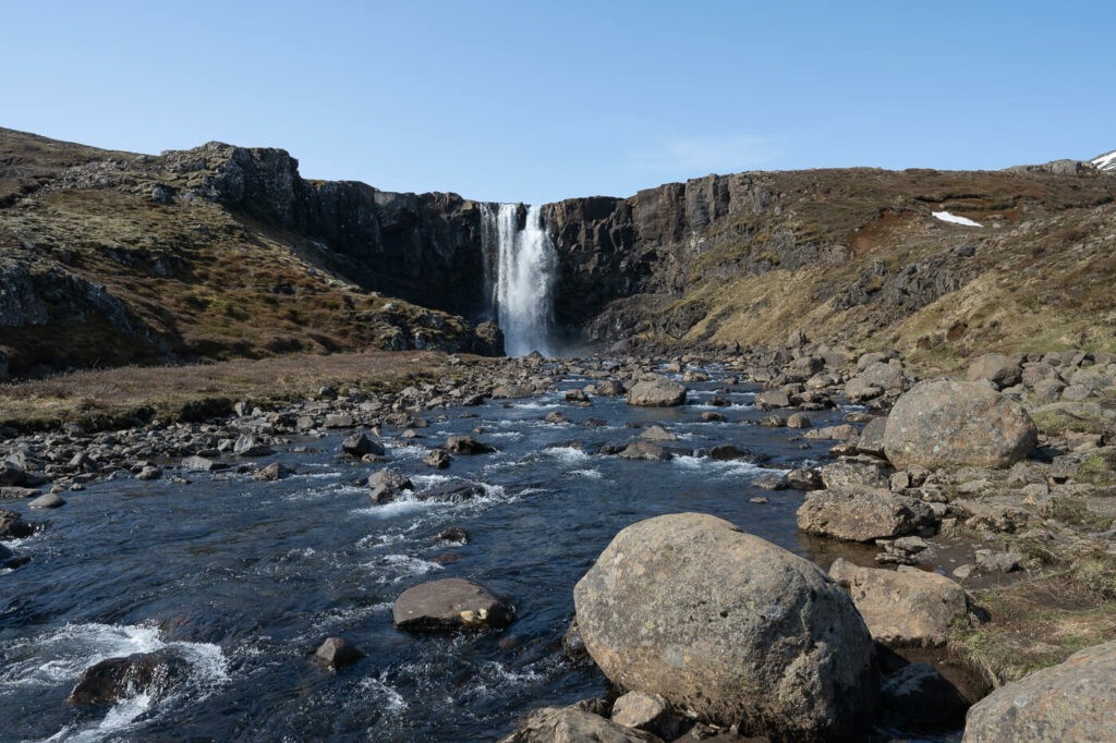 Gufufoss waterfall on a sunny day with clear blue skies
