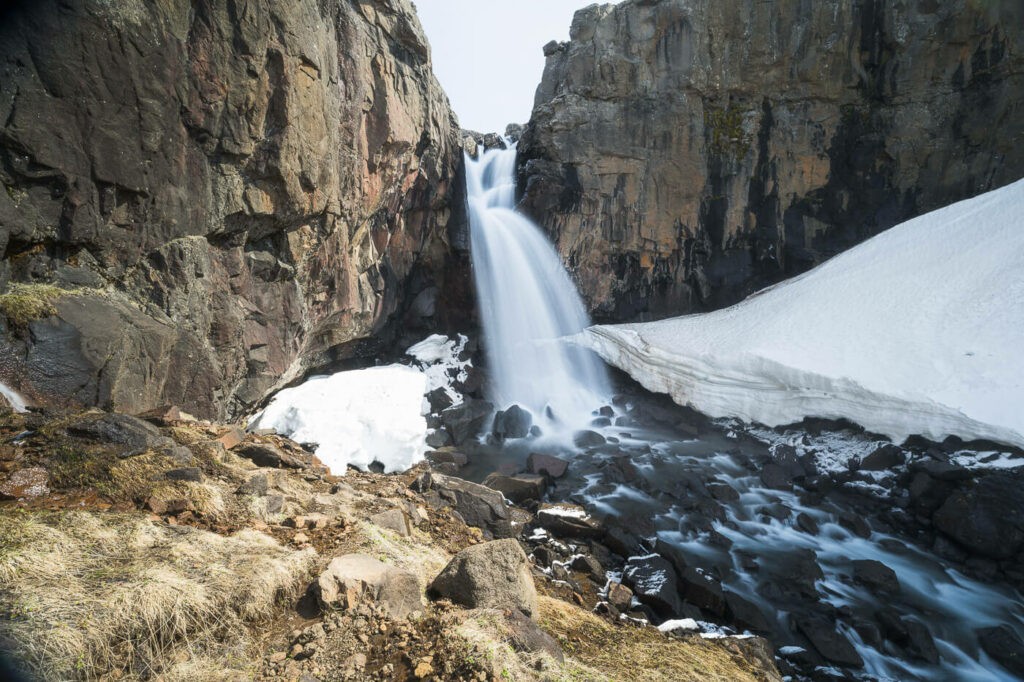 Fardagafoss waterfall with some snow around it
