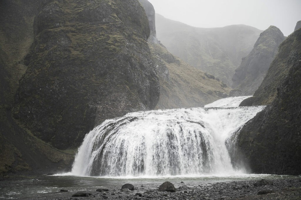 Stjórnarfoss closeup of the waterfall on a foggy and rainy day