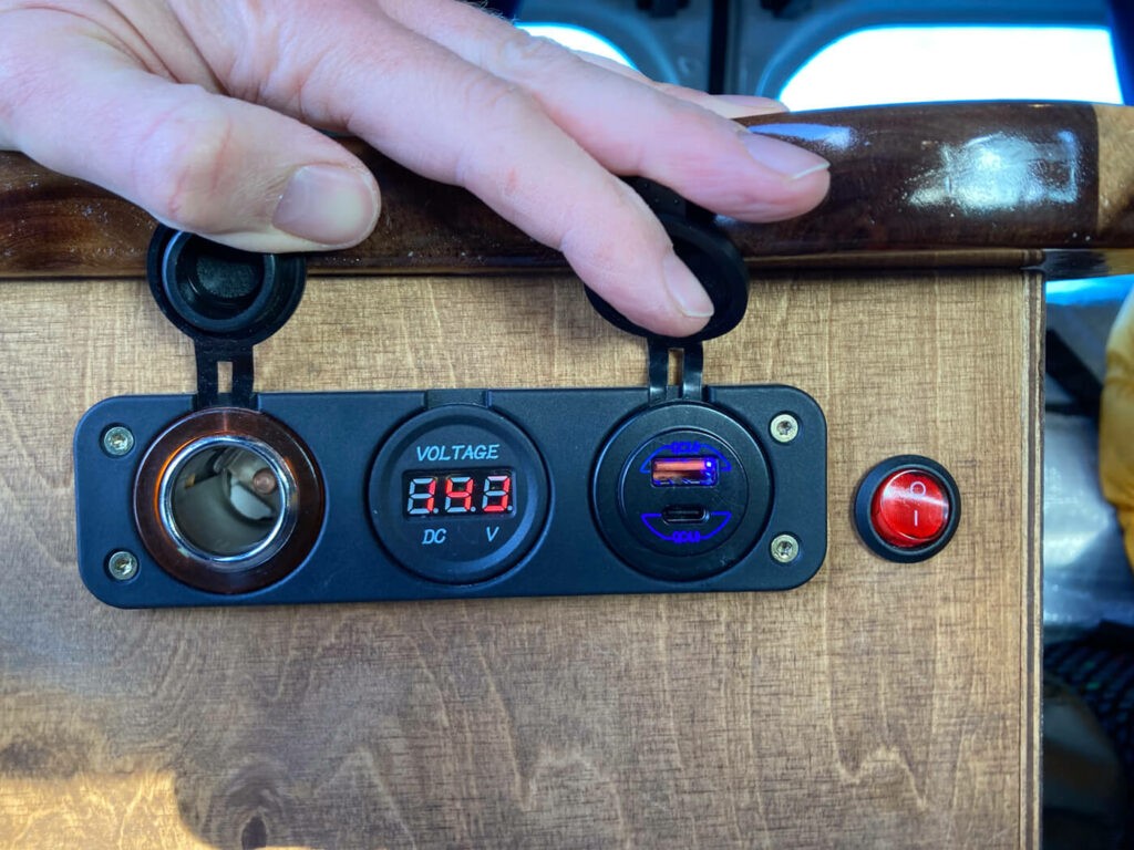 Charging ports in a van that was used for a camper van trip around iceland.
