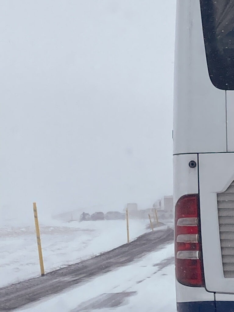 queue on a snowy road in Iceland during a storm