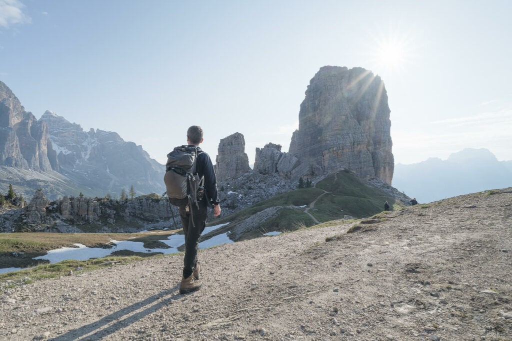 Hiker in front of Le Cinque Torri in the Dolomites