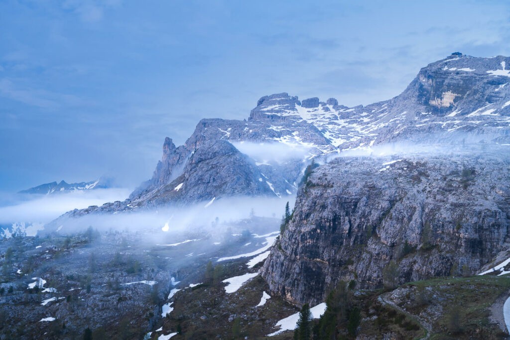 Fog around mountain in the Dolomites during the blue hour