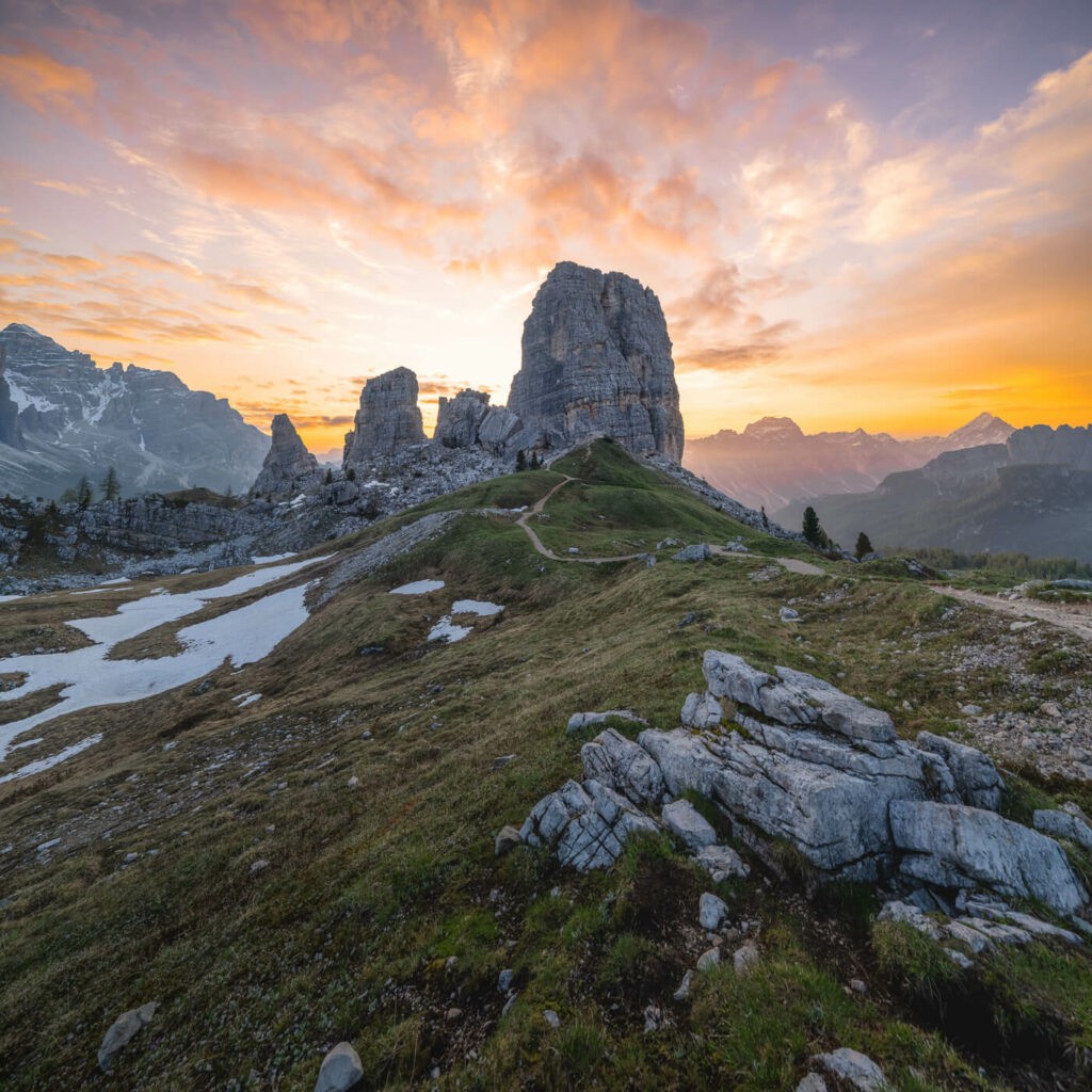 colourful sunrise in the dolomites with Le cinque torri in the middle of the image